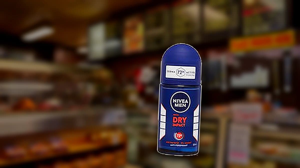 Frasco de desodorante roll-on Nivea Men Dry Impact sobre repisa de baño con luz matutina suave
