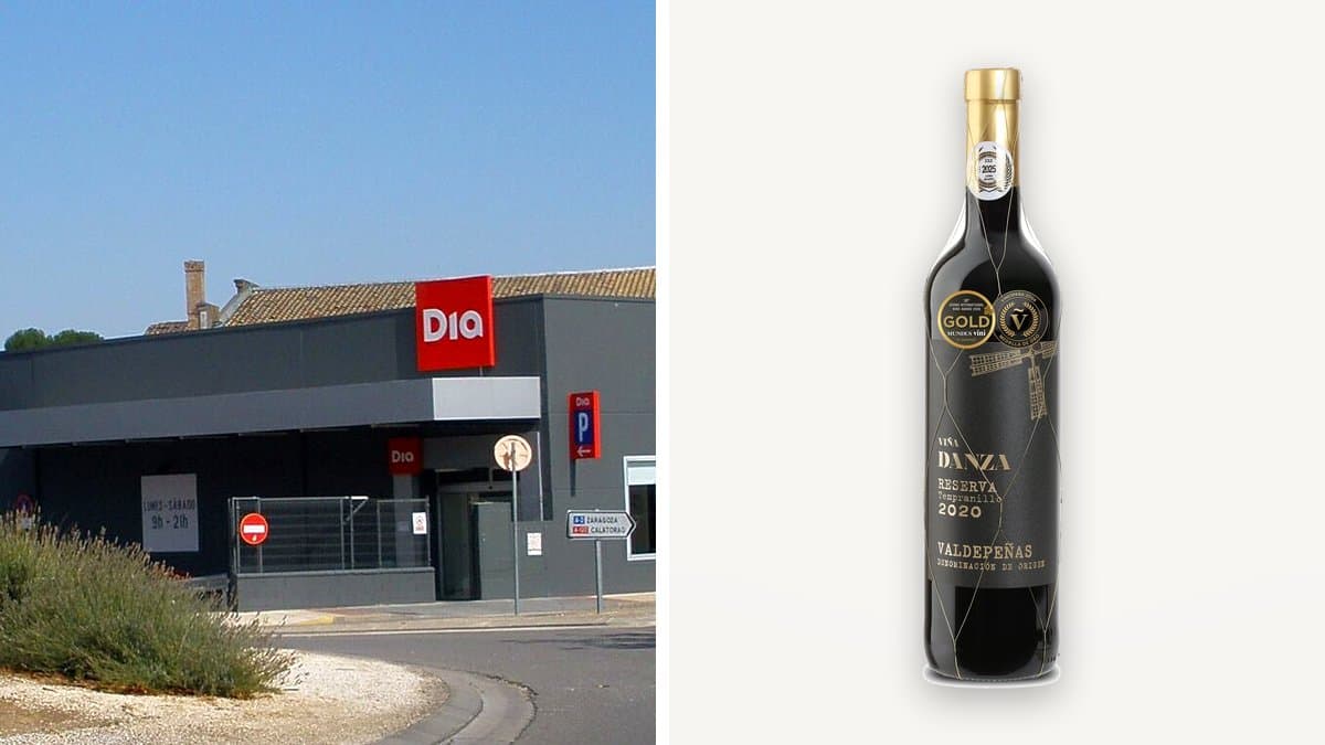 Botella de vino tinto reserva Viña Danza y copa llena en mesa de terraza al atardecer