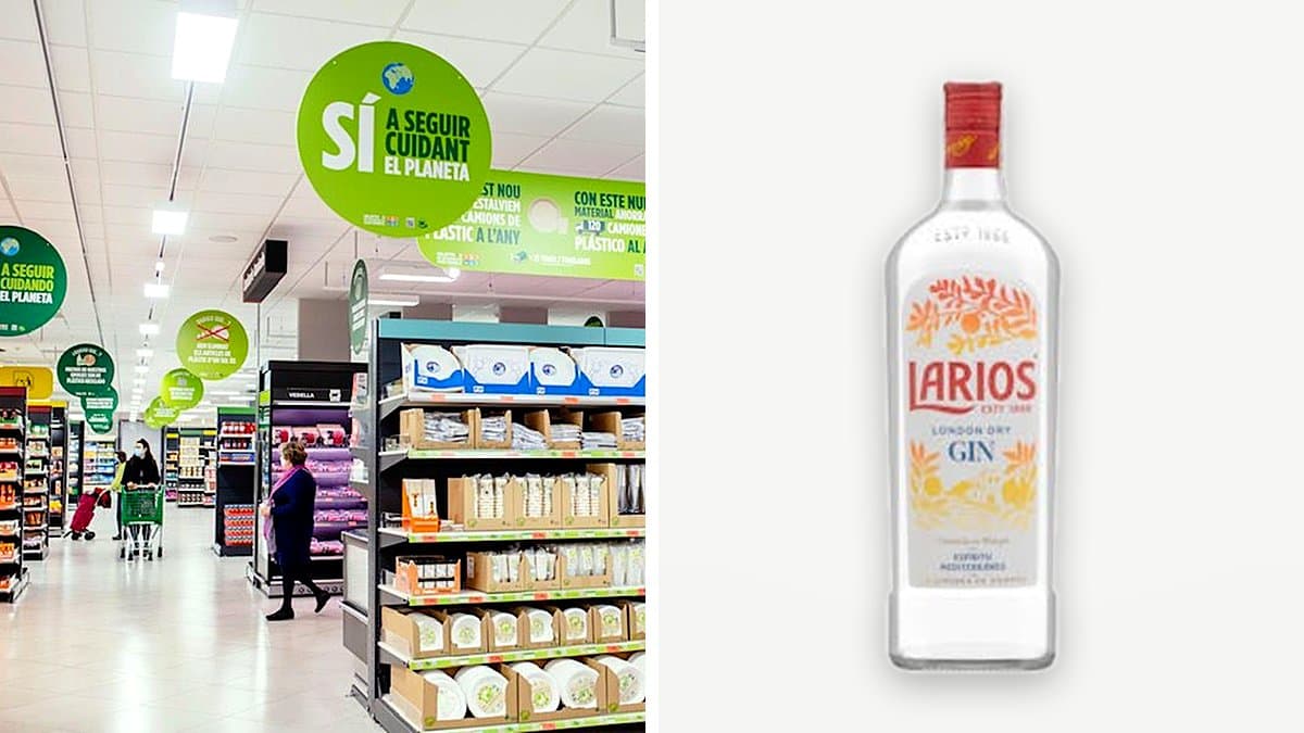 Botella de ginebra Larios London Dry sobre barra de casa junto a copa de gin-tonic con hielo, lima y tónica, luz dorada de atardecer