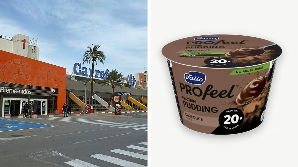Tarrina abierta de natilla de chocolate Valio Profeel Protein con cuchara en superficie de madera