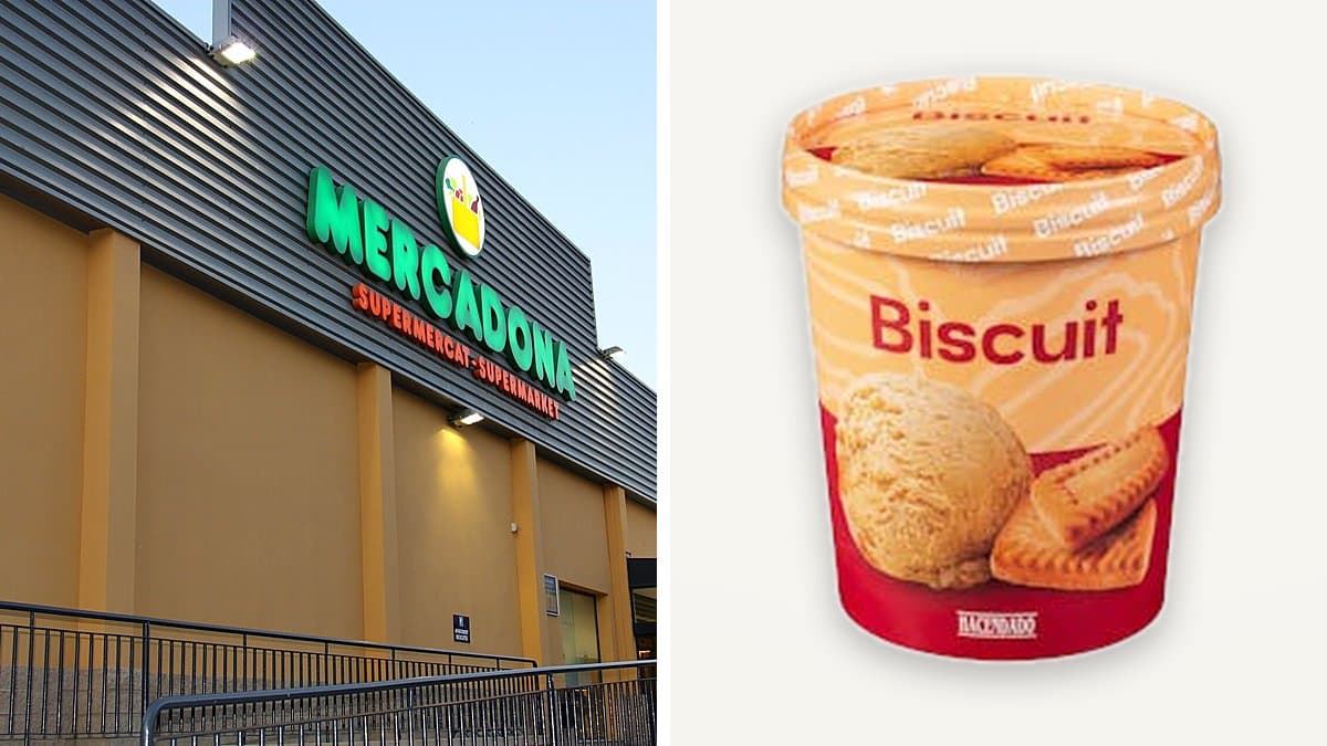 Tarrina abierta de helado Biscuit con galleta caramelizada, cuchara de metal, superficie de mármol.