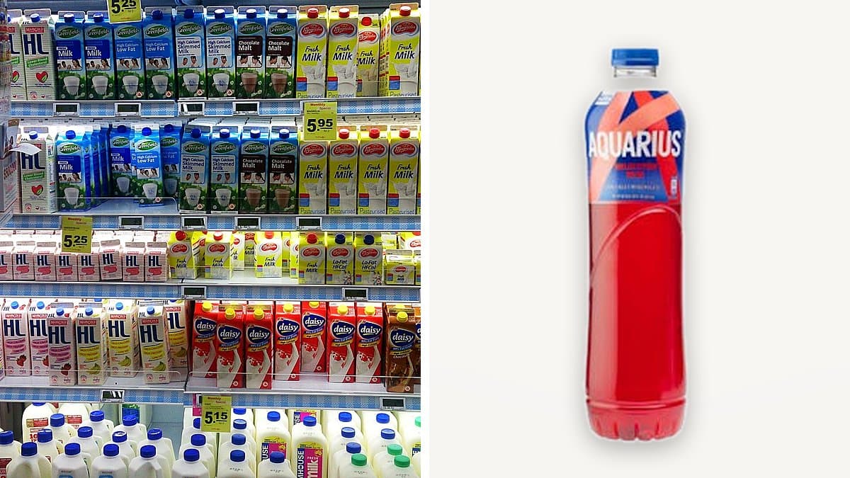 Botella grande de Aquarius melocotón rojo en estantería de supermercado con luz cálida de tarde, condensación en el plástico